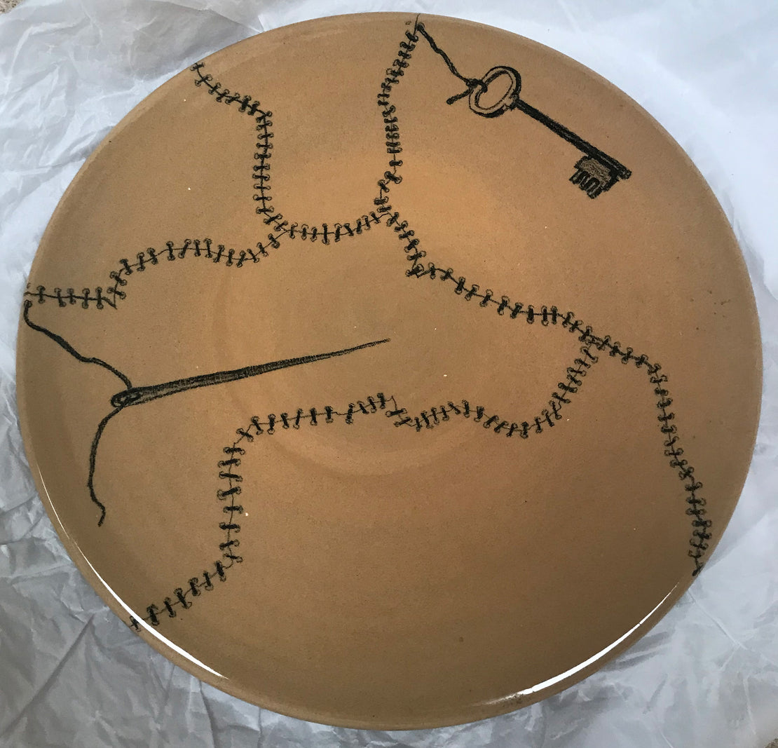 Plate with needle, sewing and key
